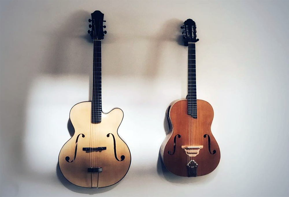 handmade guitars hanging on a wall