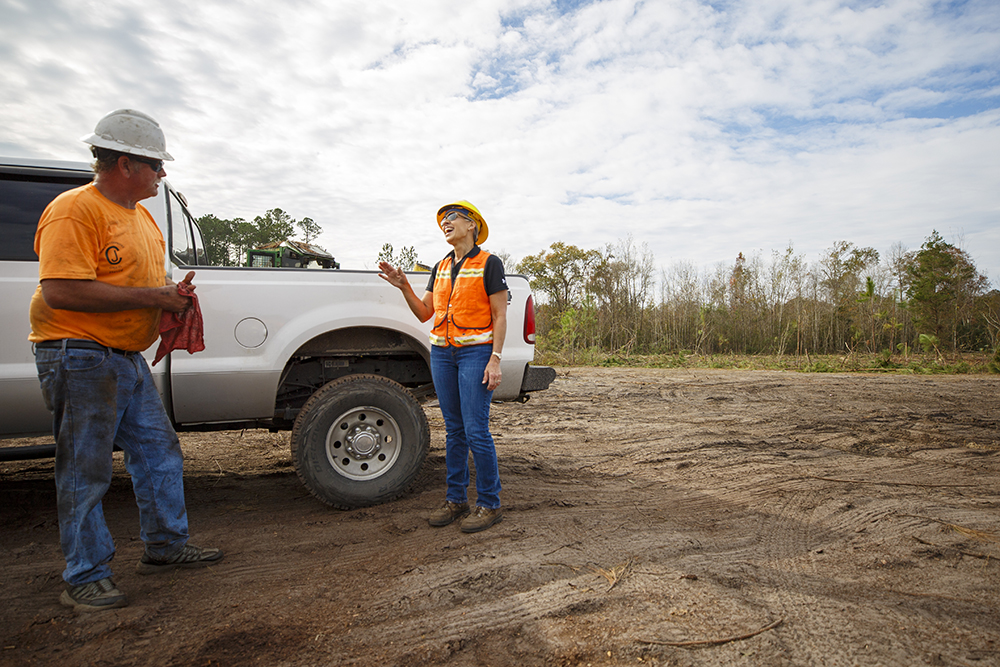 Terri talks with crew member by truck