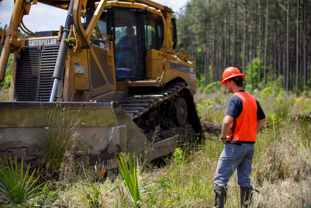 Wes oversees a bulldozer performing land shearing