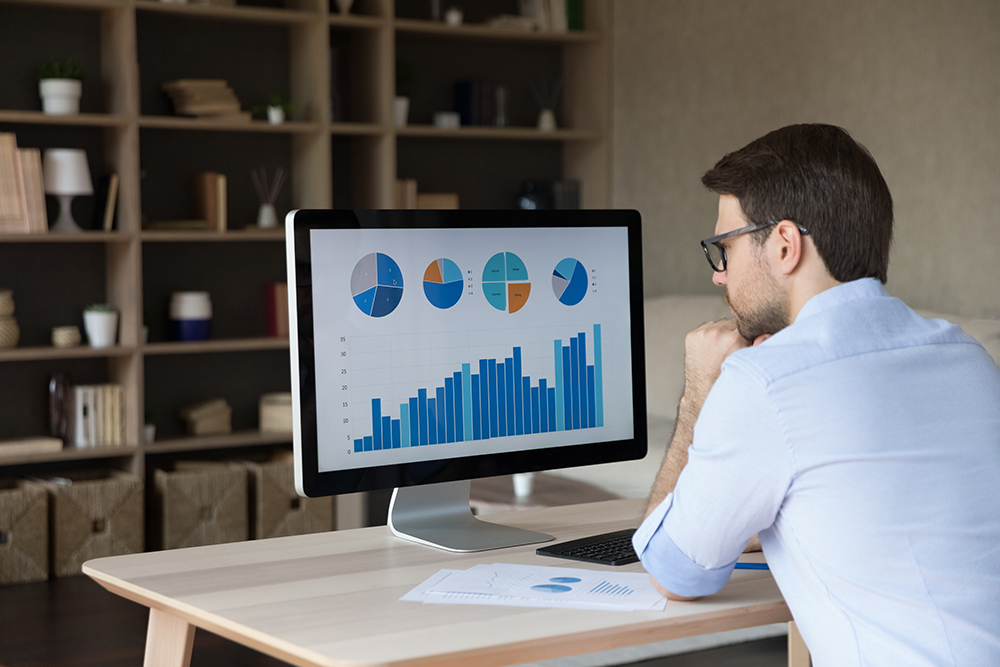 Man staring at computer monitor in office