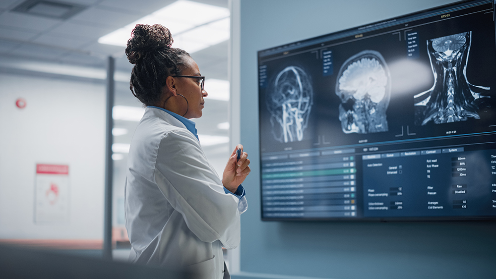 Doctor looks at brain scan on screen