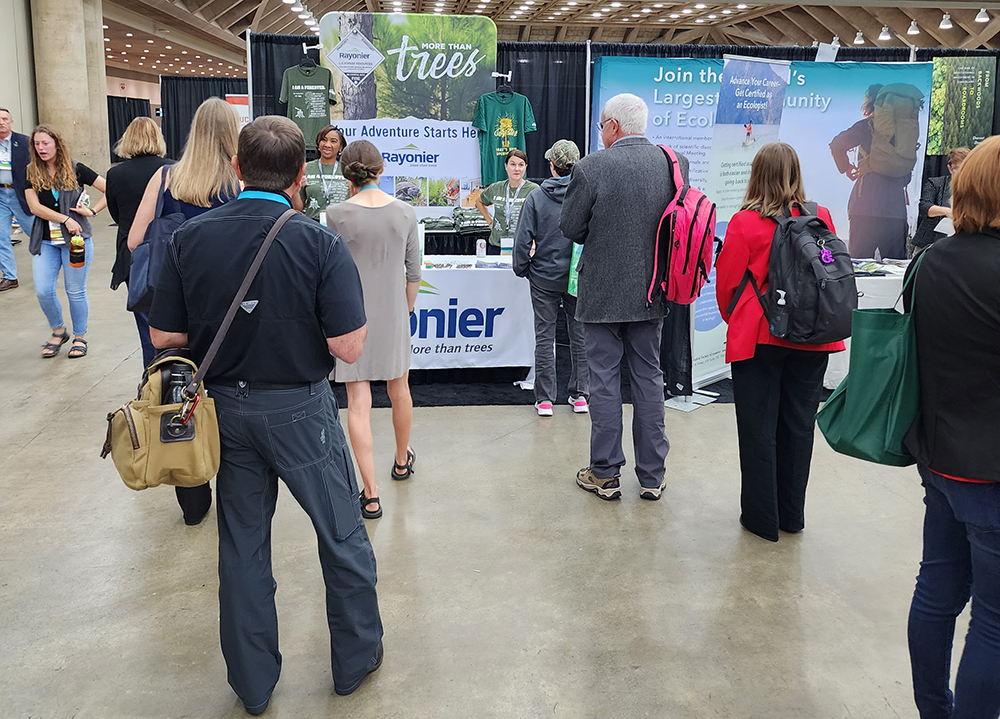 long line of people standing at New England Forestry table