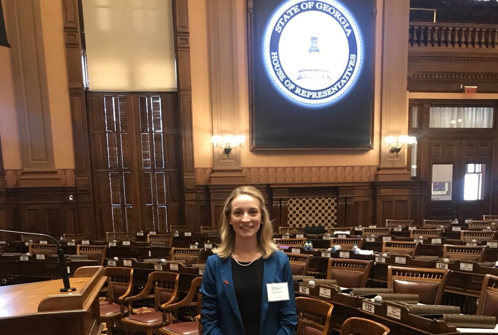 Shawn stands in an empty Georgia State House of Representatives before a presentation.